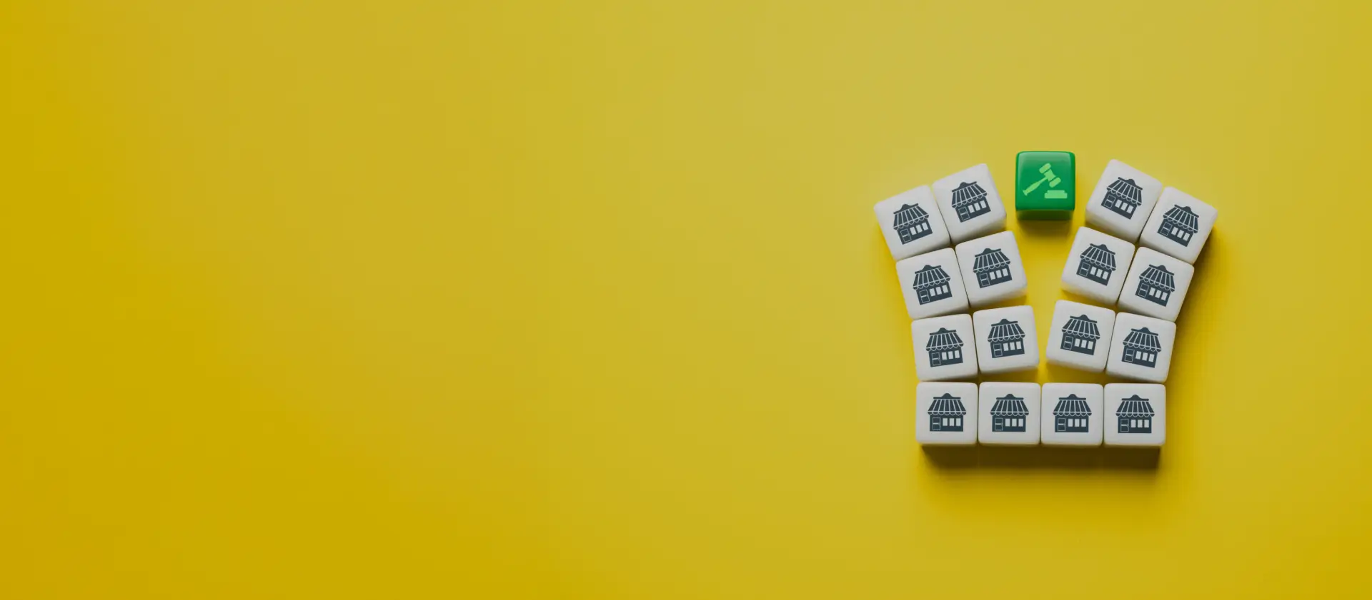 White tiles with house icons arranged in a grid, with a green gavel icon representing asset division in divorce settlements.
